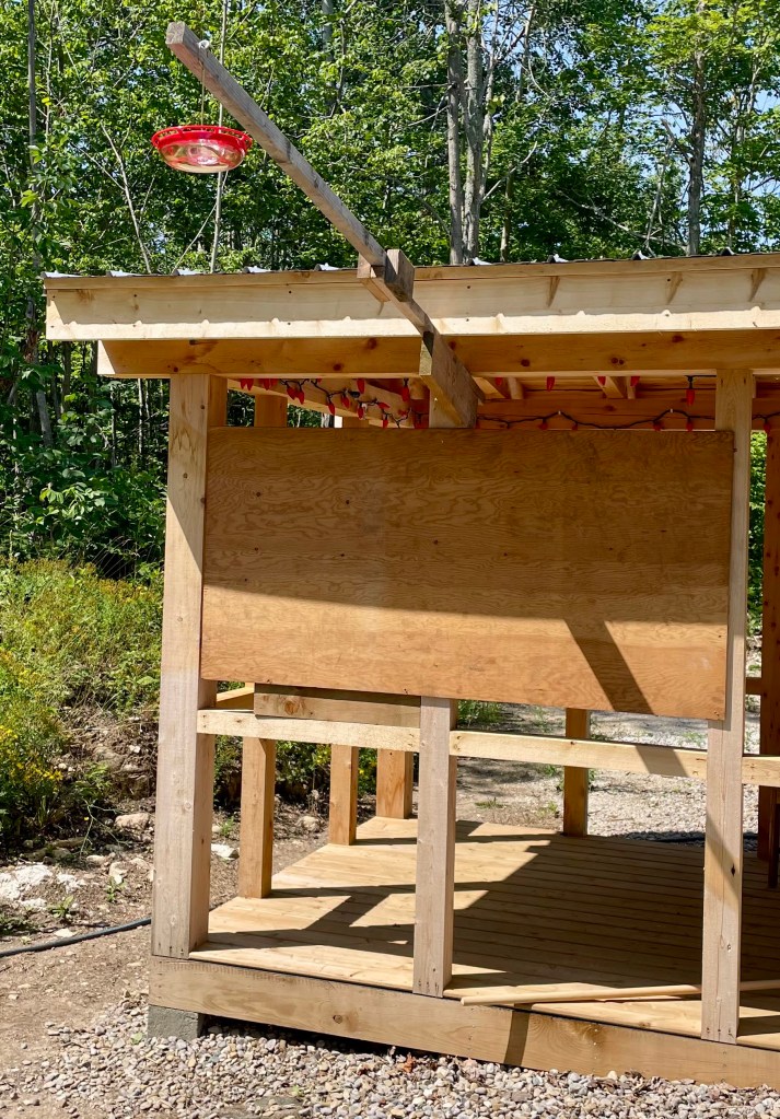 plywood covers the horizontal beams so bears cannot climb the wall