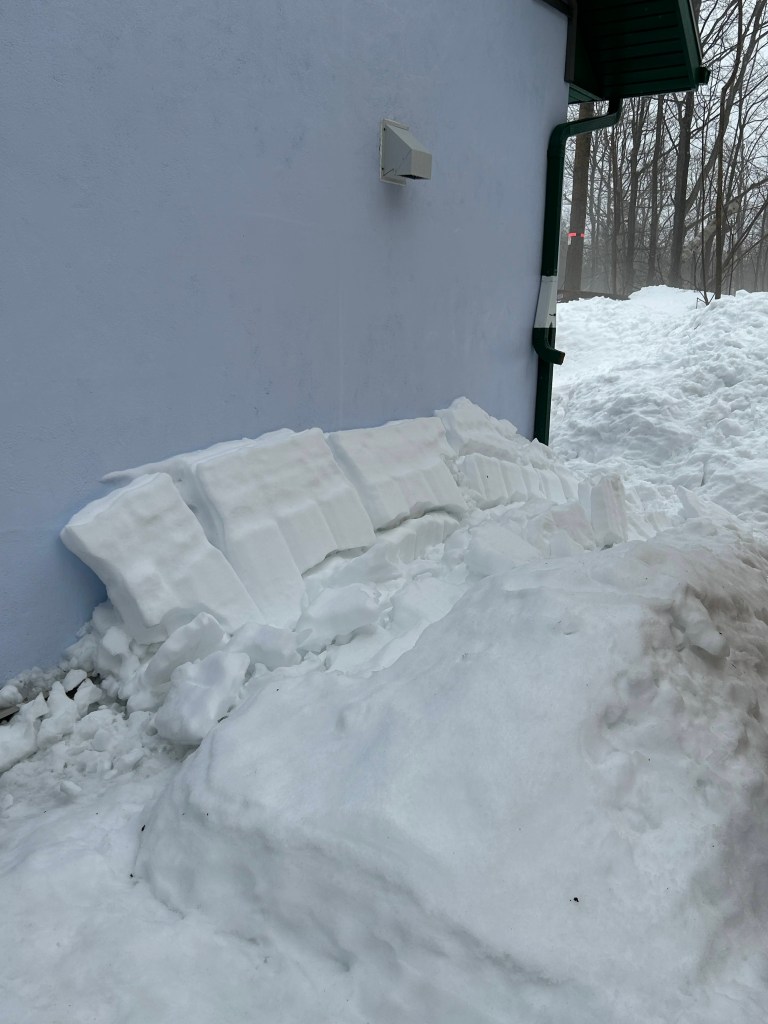 snow piled up on the west wall