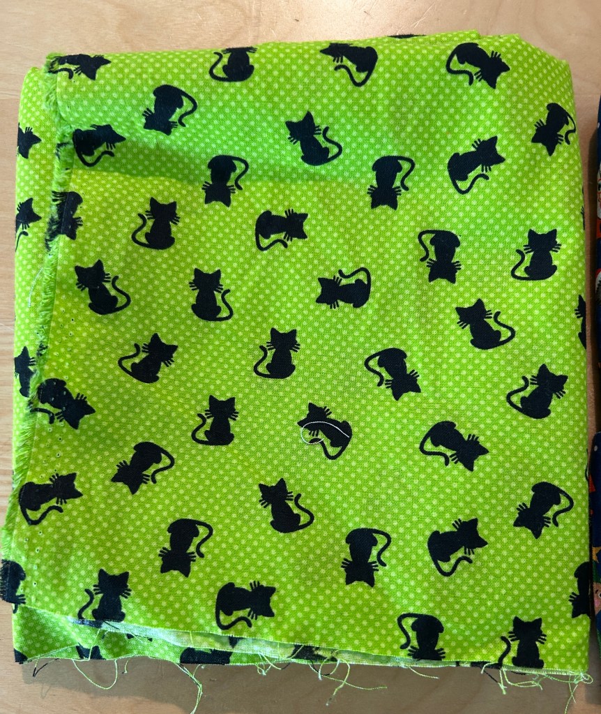 Raw material for making catnip mouse toys. Lime-green with black cats.