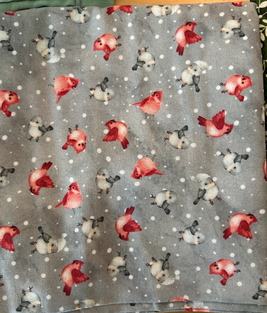 Raw material for making catnip mouse toys. Grey background and lots of printed birds.